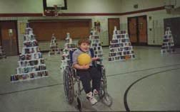 Special Education child with ball in PE class